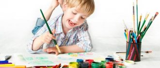 Boy painting with a brush